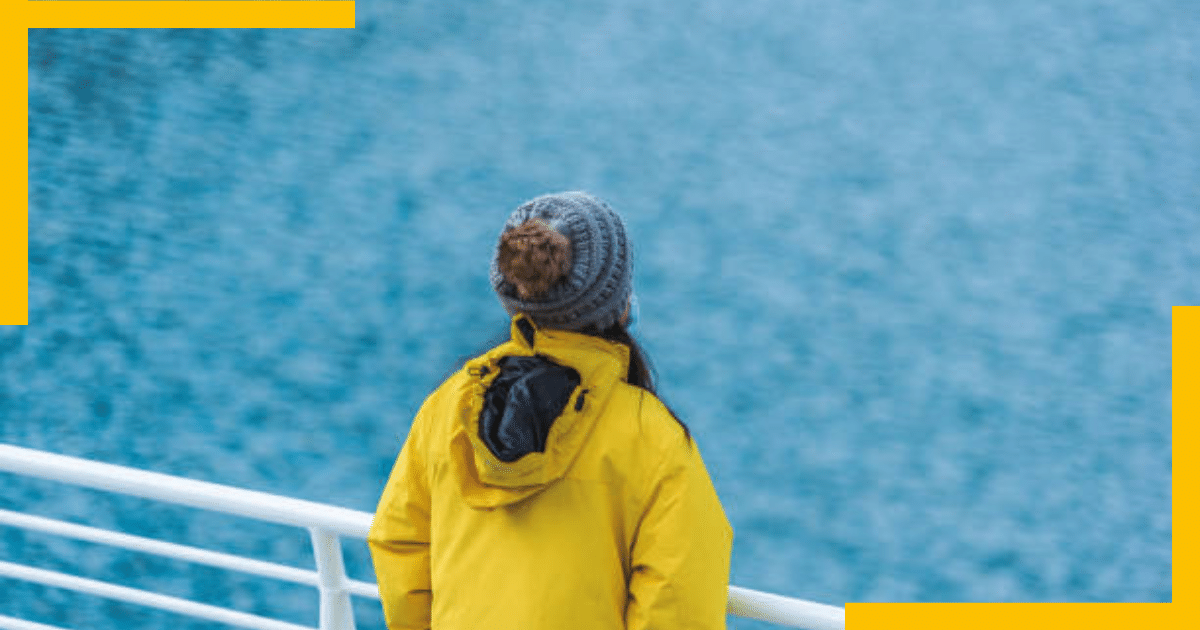 A woman standing in a yacht in a sea