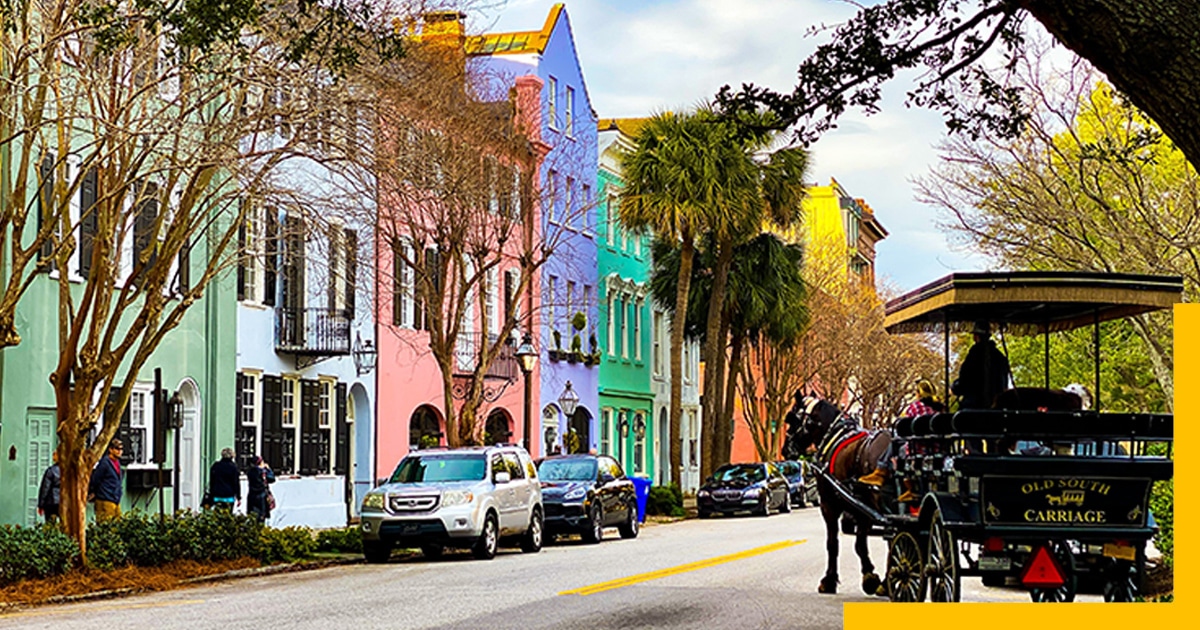 A street with colorful houses and a horse carriage