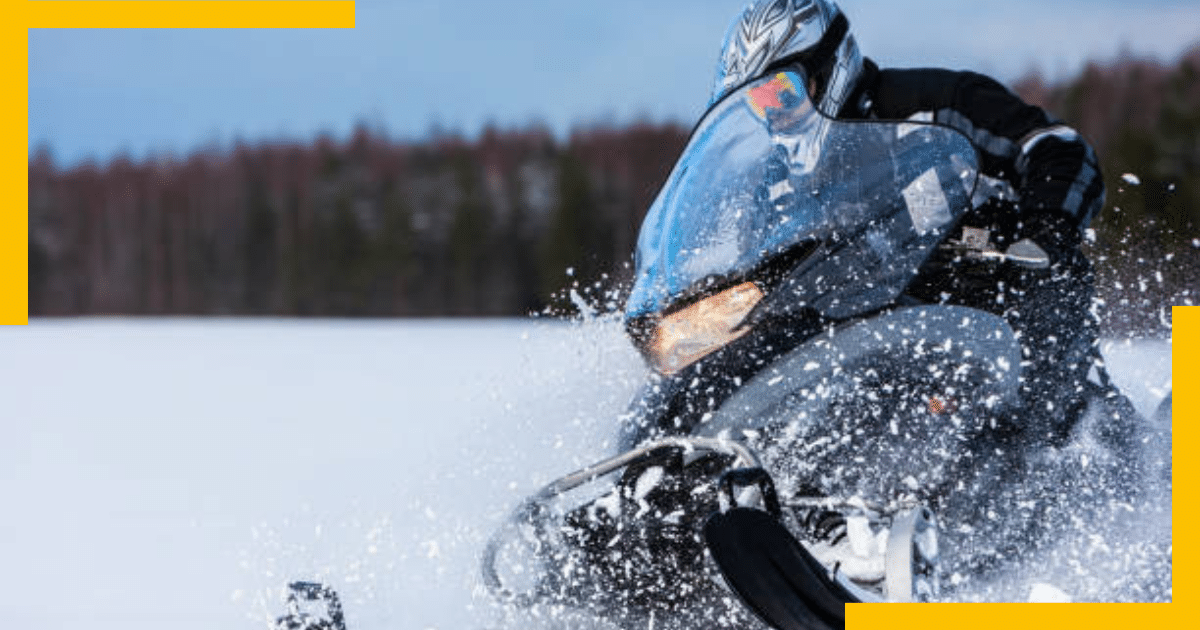 A man riding a snowmobile