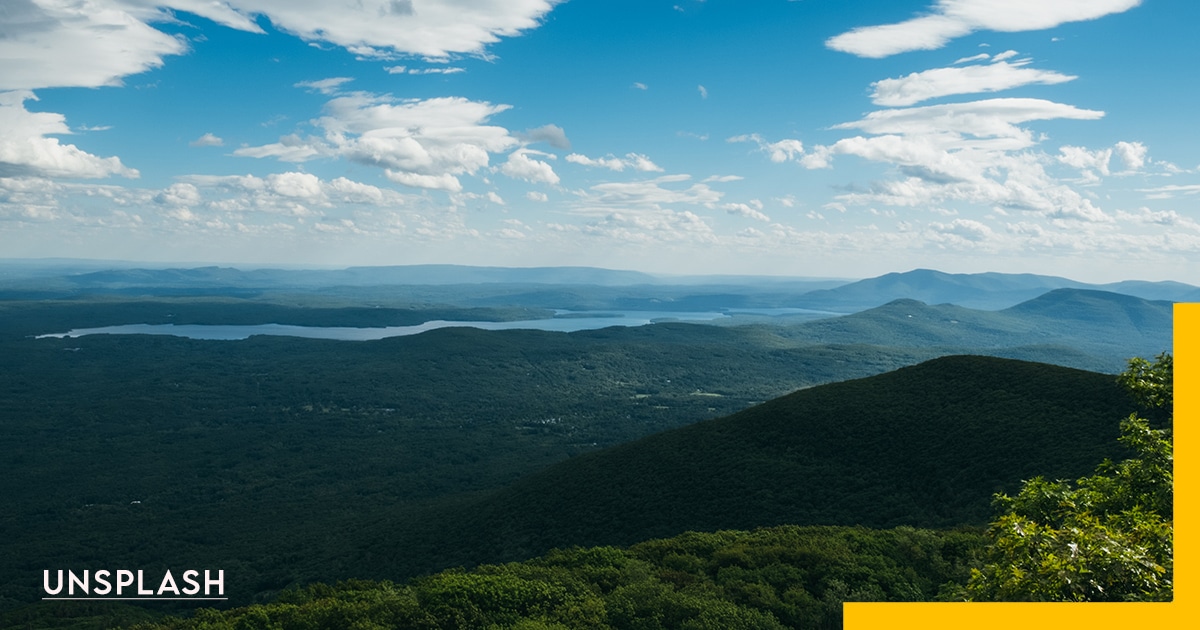 United States, The Catskills, NY, water sky clouds, greenery and mountains