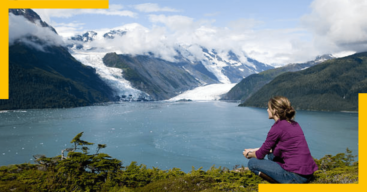 A woman sitting and watching the lake