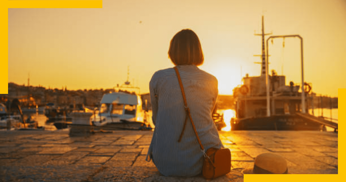 A woman sitting by the sea