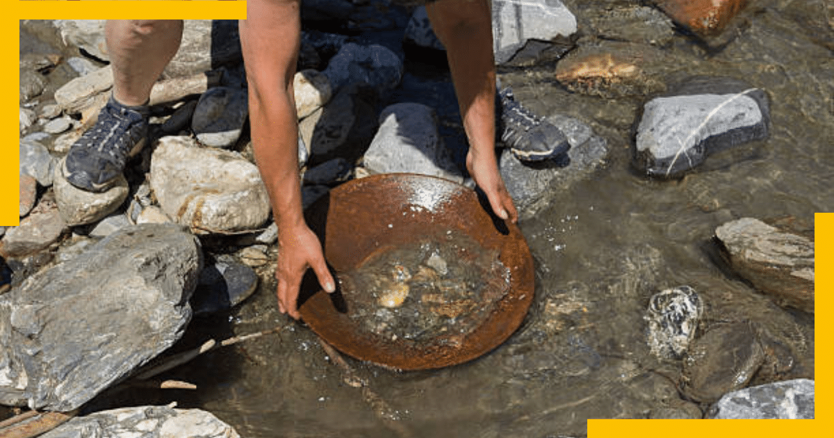 A man panning gold in a river