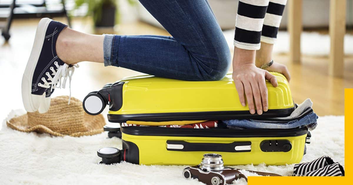 Women Packing Yellow Suitcase