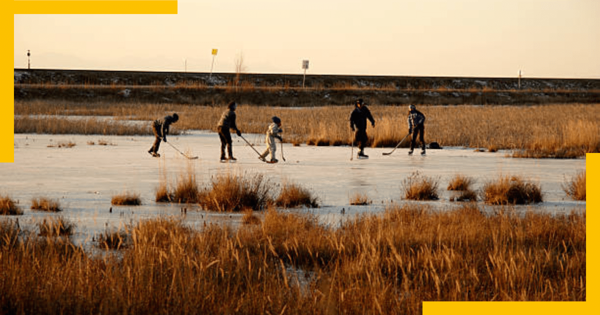 People playing hockey while ice skating