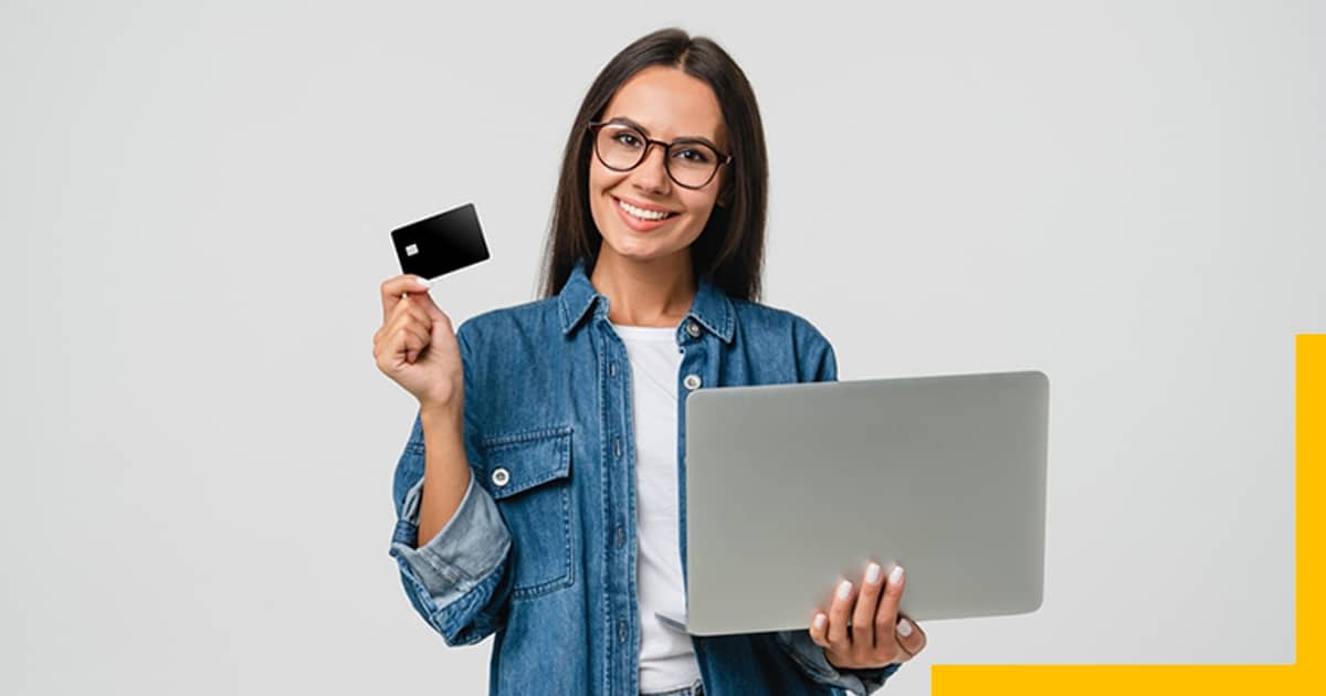 Girl holding Laptop and Credit Card