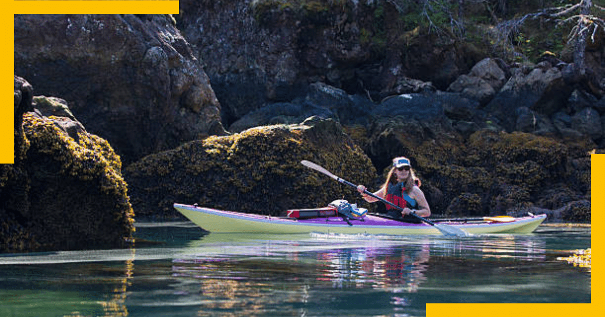 A woman kayaking in the lake in Alaska